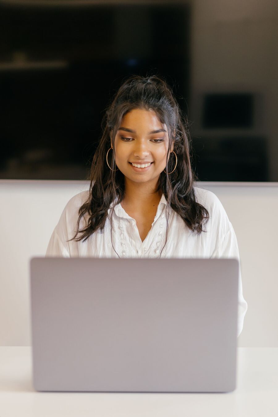Smiling student working on her laptop